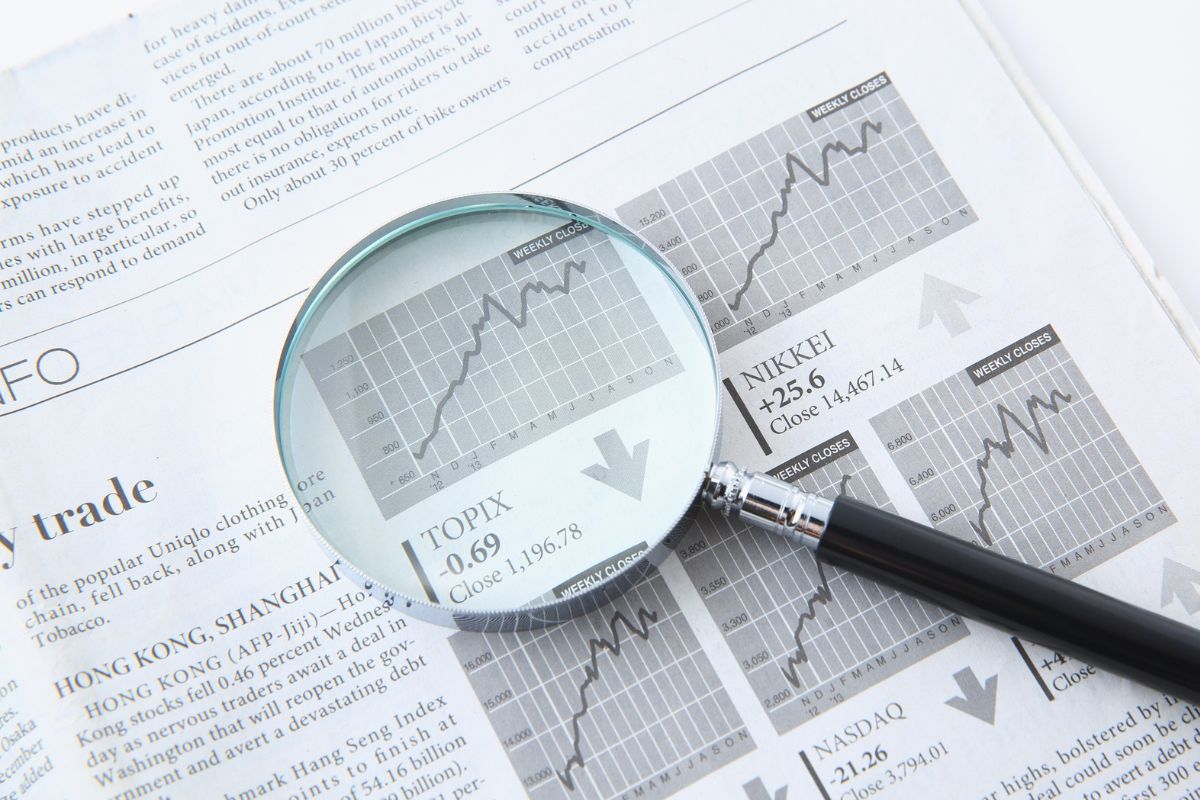 A picture of a magnifying glass and a graph. 