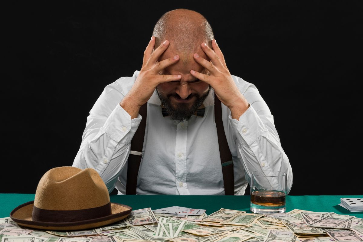 A picture of a man having gambling problems.