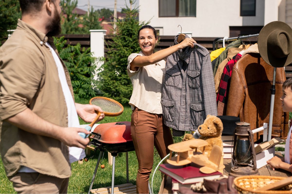 A picture of a mother looking at garage sale. 