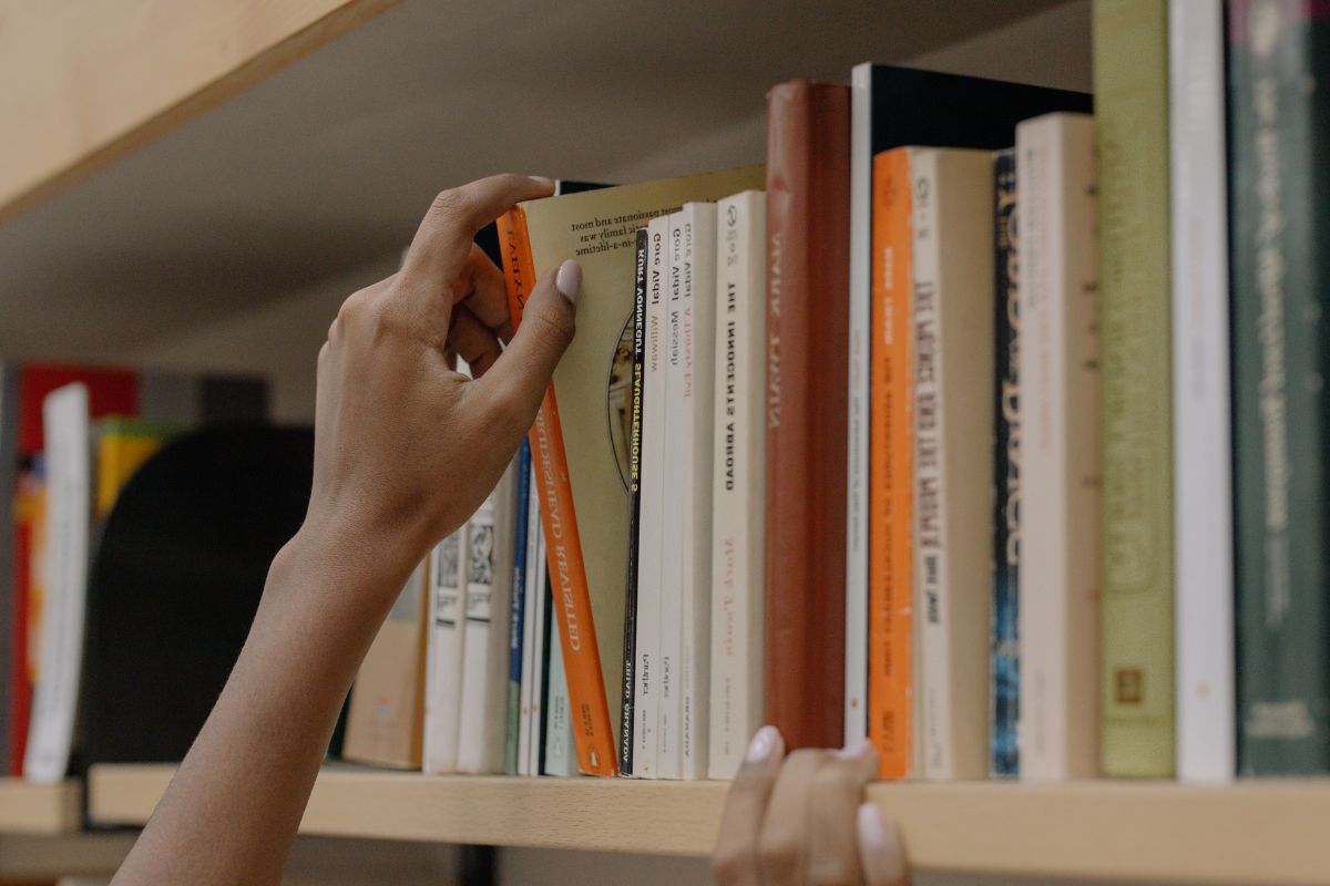 A picture of someone getting books from the library.