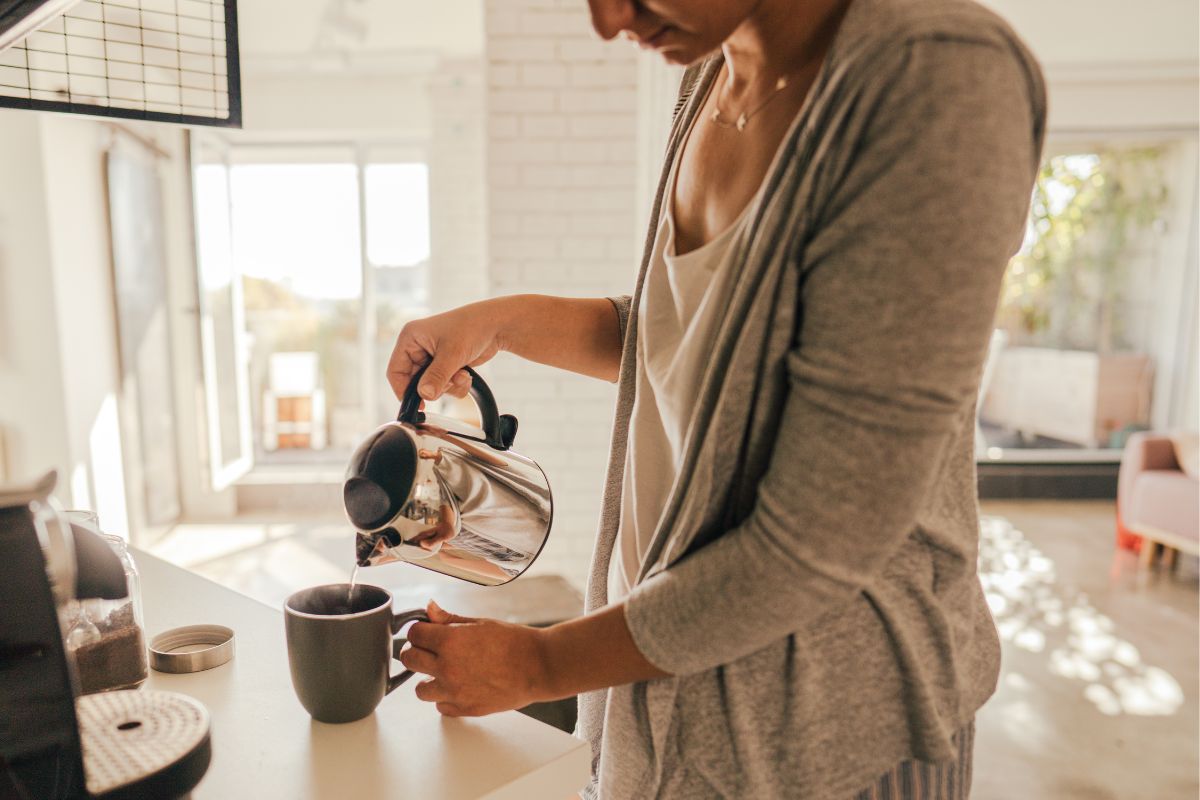 A picture of a woman making coffee.