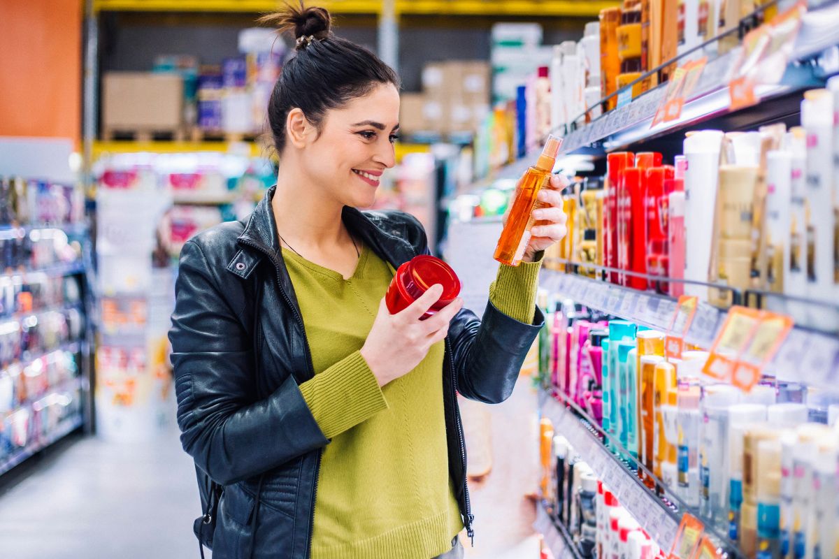 A picture of a lady comparing prices.
