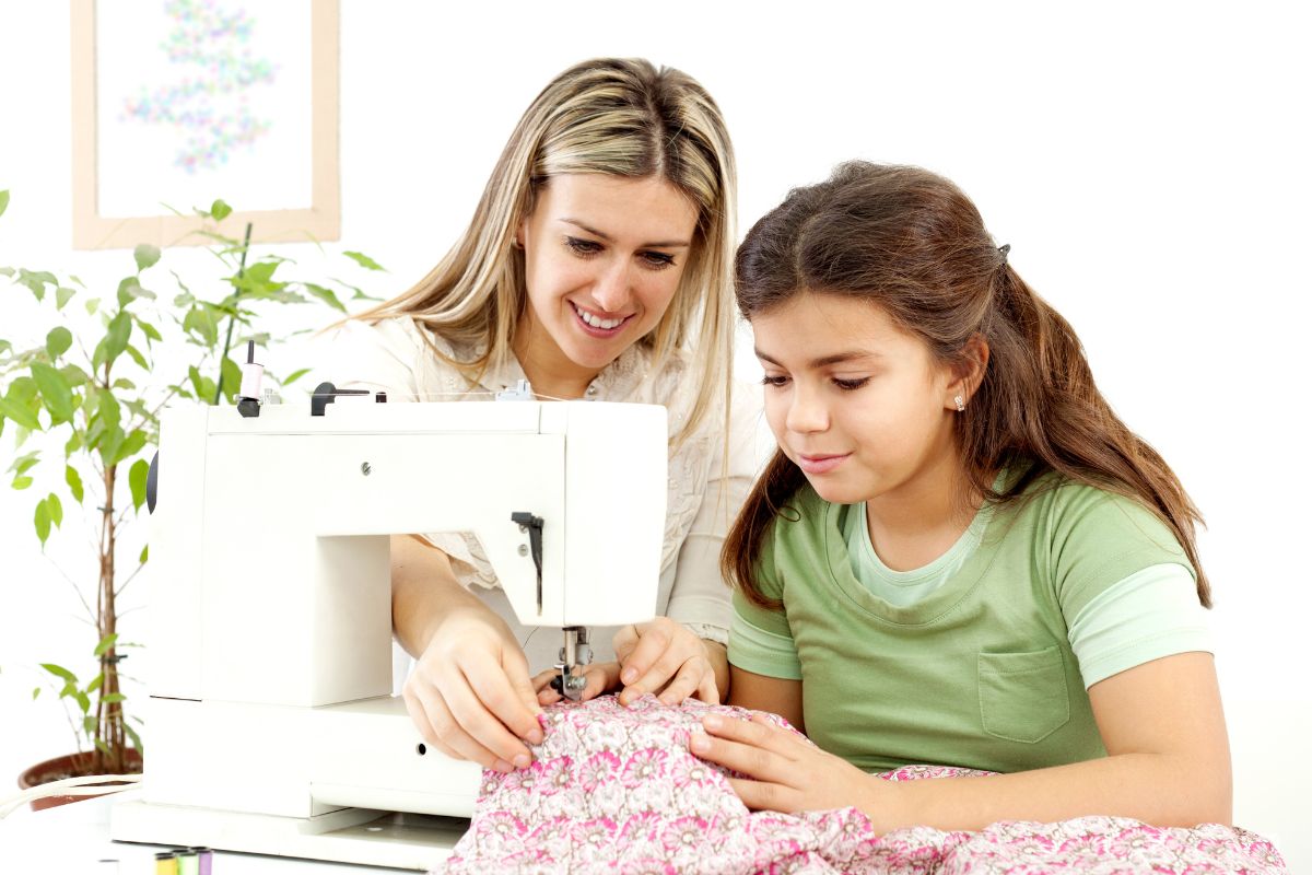 A picture of a mother and her daughter sewing.
