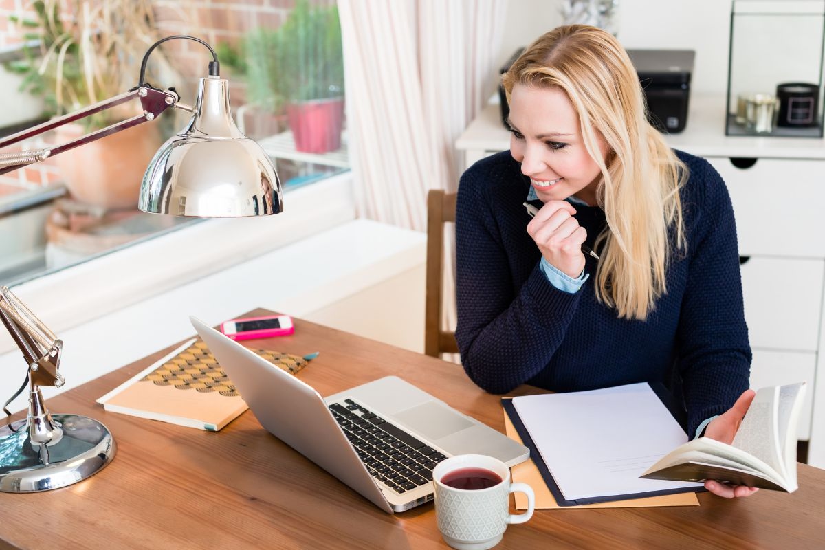 A picture of a lady looking at her laptop.