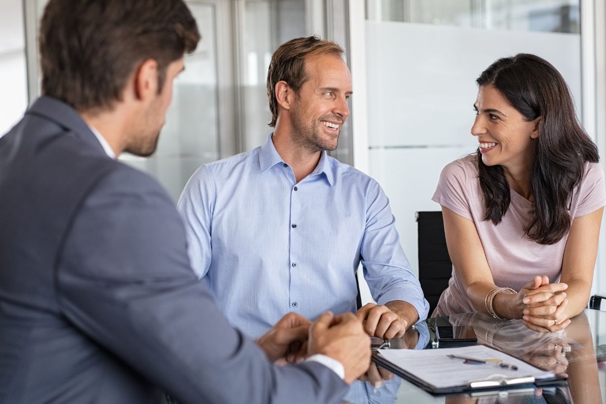 A picture of a couple with a financial advisor.