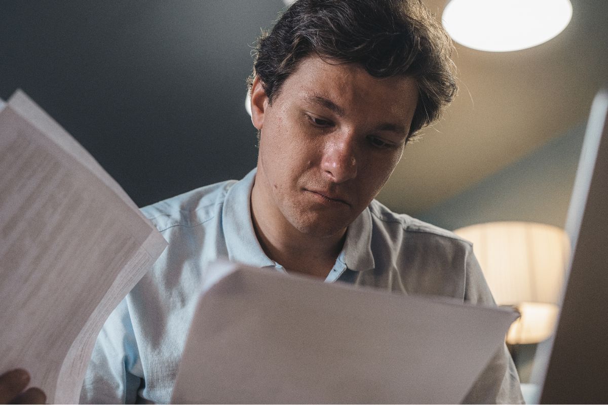 A picture of a man looking at papers.