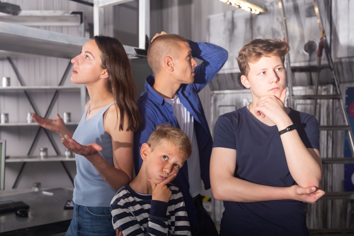 A picture of siblings solving an escape room. 