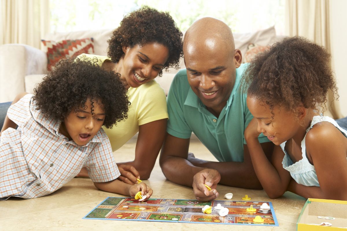 A picture of a family playing a board game.