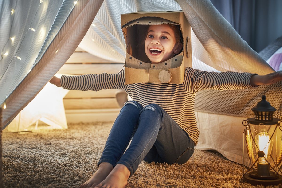 A picture of a child camping and roleplaying.