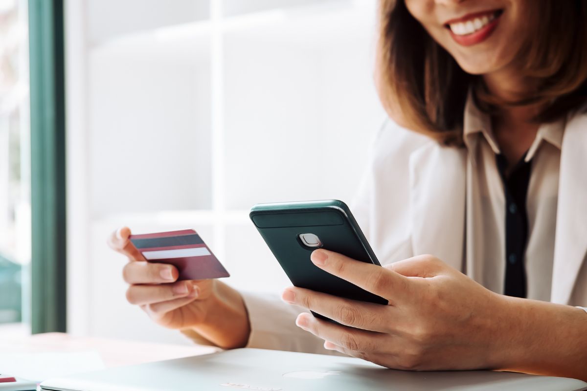 A picture of someone looking at their credit score on their phone.