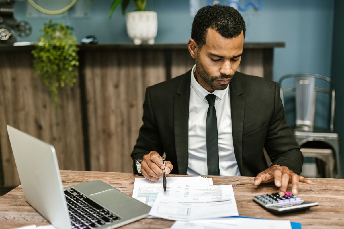 A picture of a man calculating his financials. 