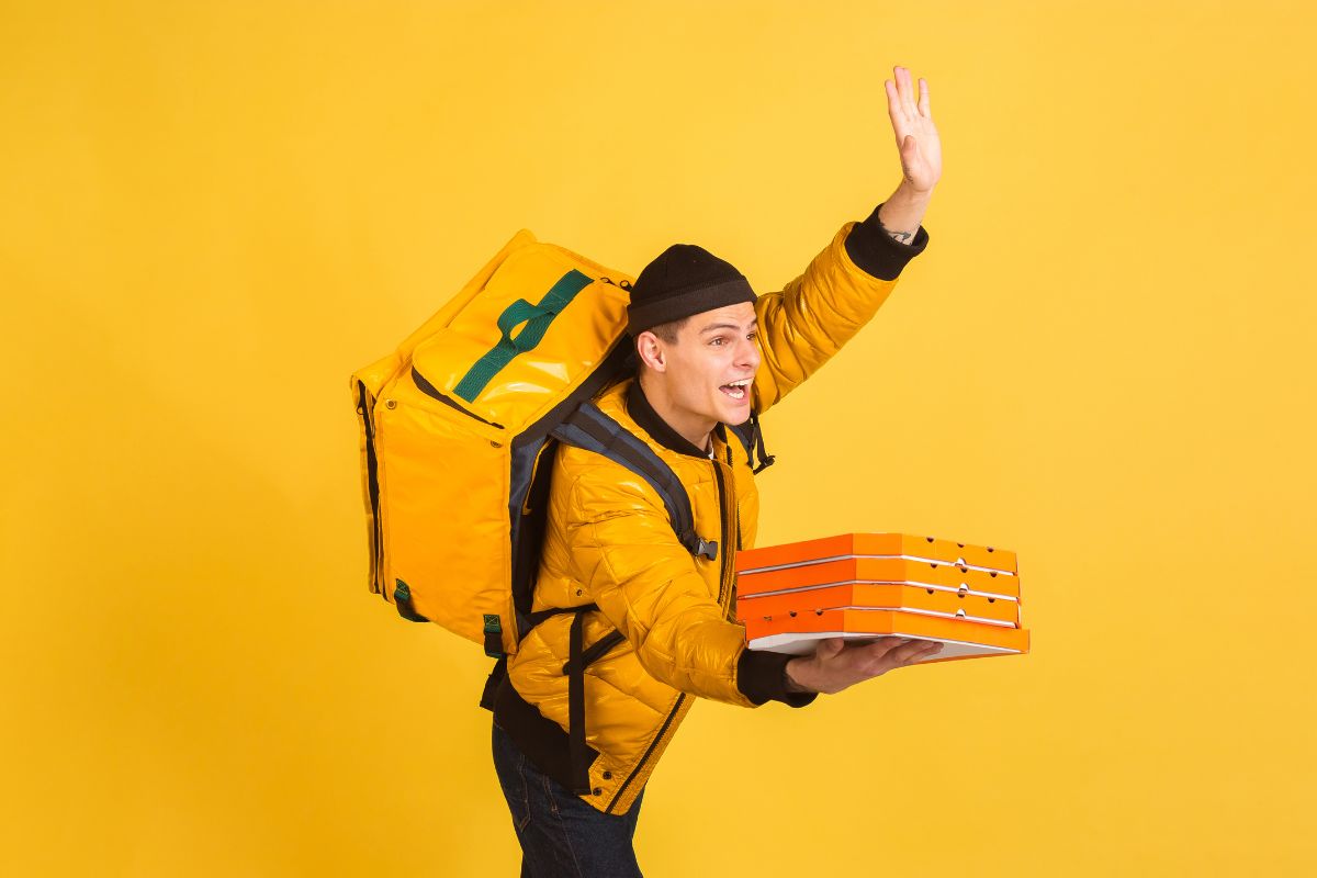 A picture of a man doing deliveries as a side hustle.