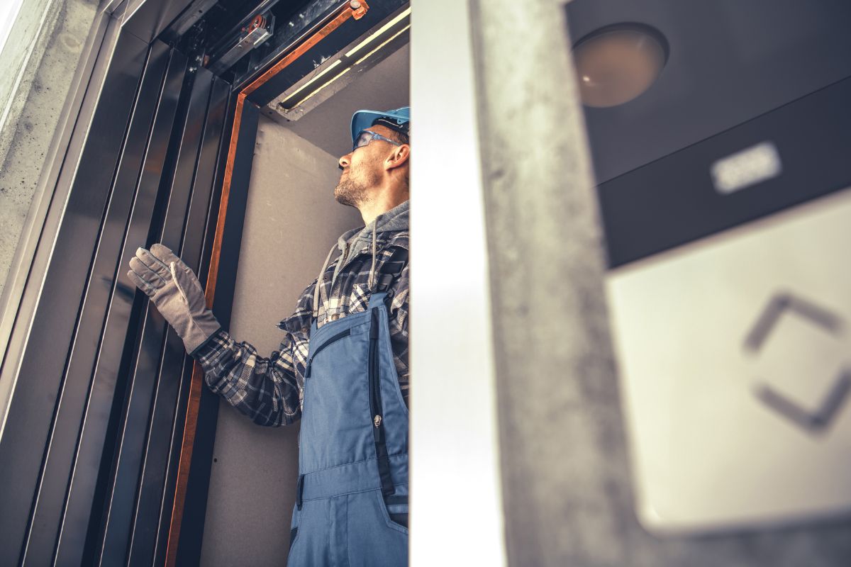 A picture of an elevator installer.