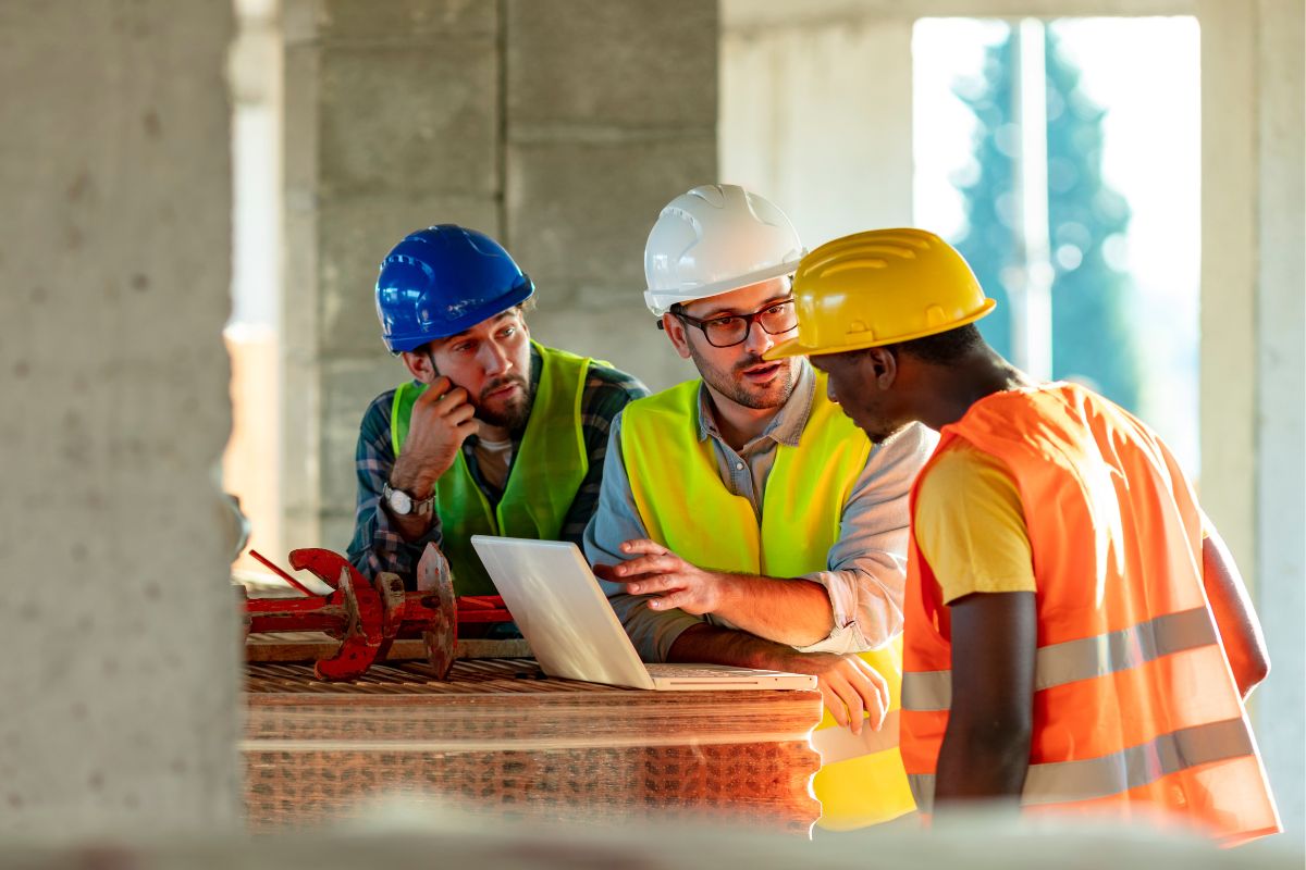 A picture of a Construction Manager with his workers.