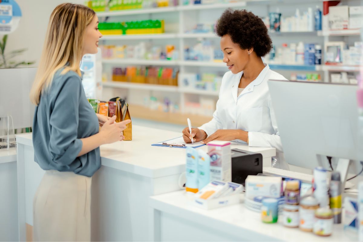 A picture of a Pharmacy Technician with her customer. 