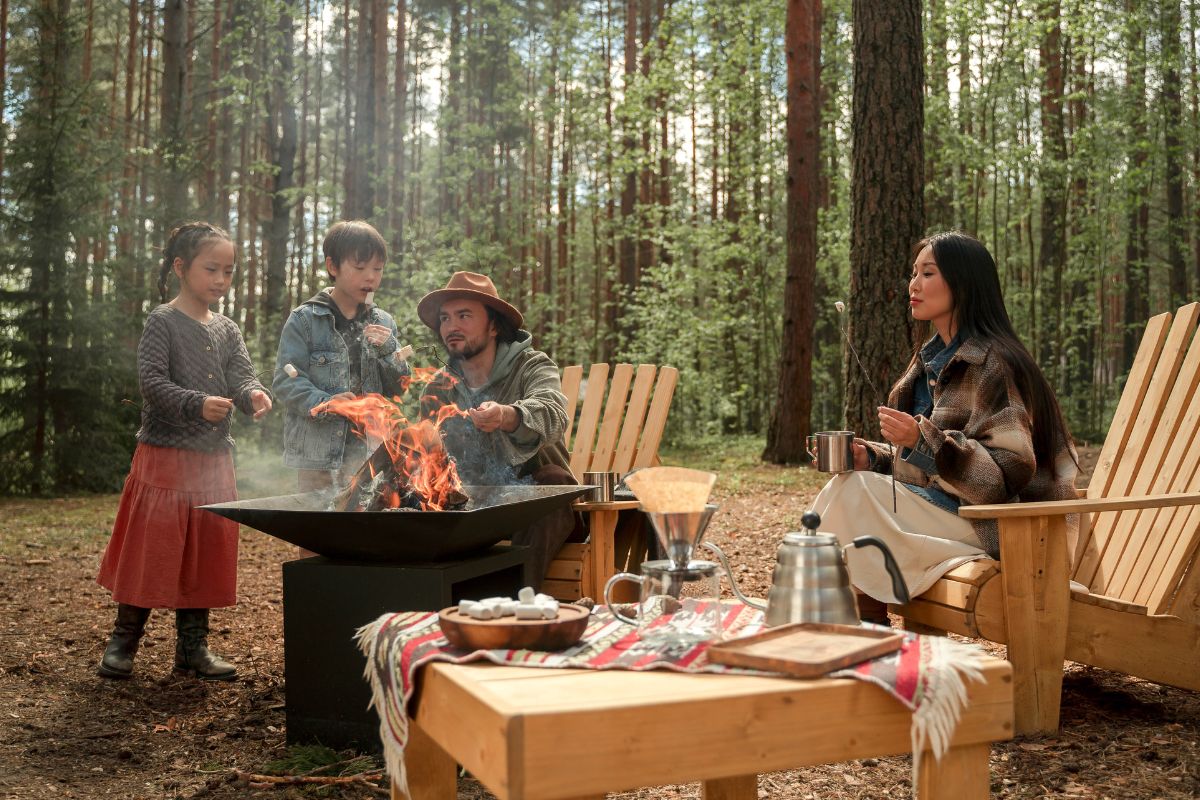 A picture of a family camping and eating. 