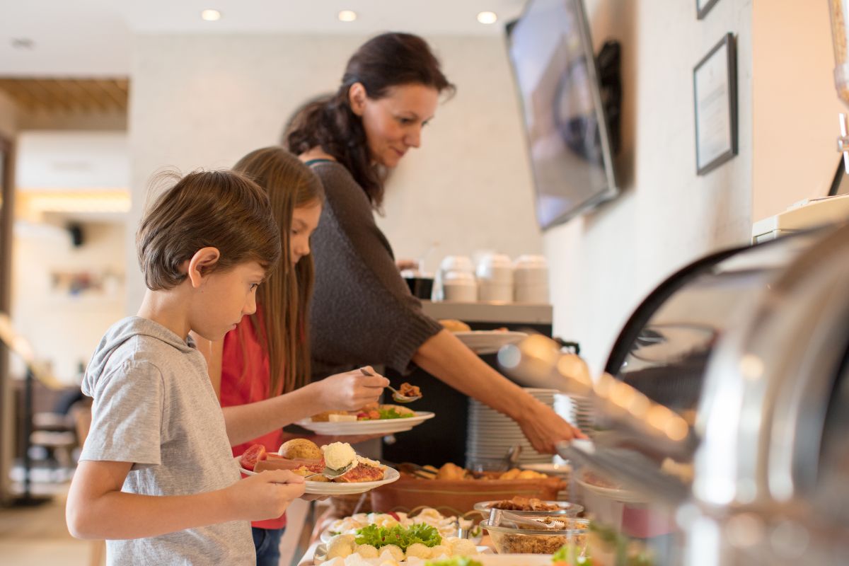 A picture of a family dining at a hotel buffet. 