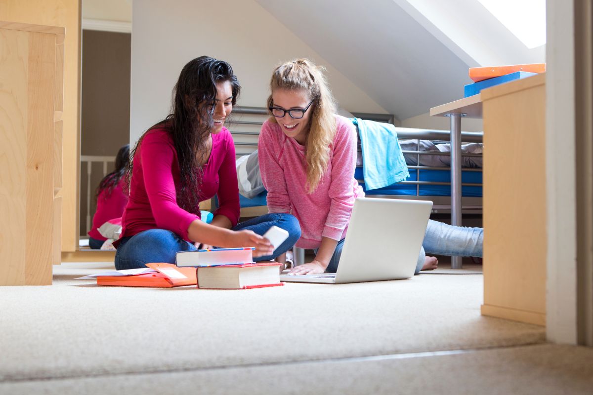 A picture of ladies looking at accommodations online. 