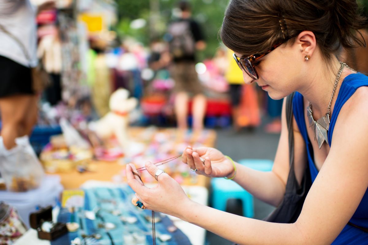 A picture of a lady looking at a craft.