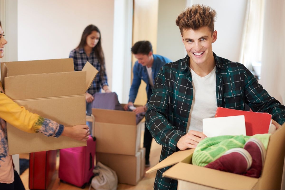 A picture of a teen helping a family move out.
