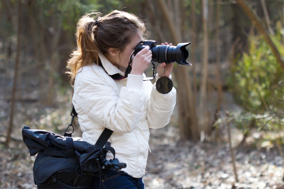 A picture of a lady taking a photo.