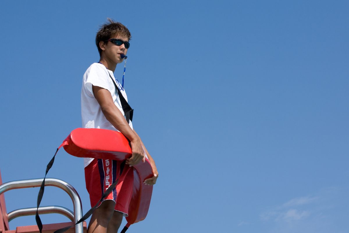 A picture of a man doing lifeguard duties.
