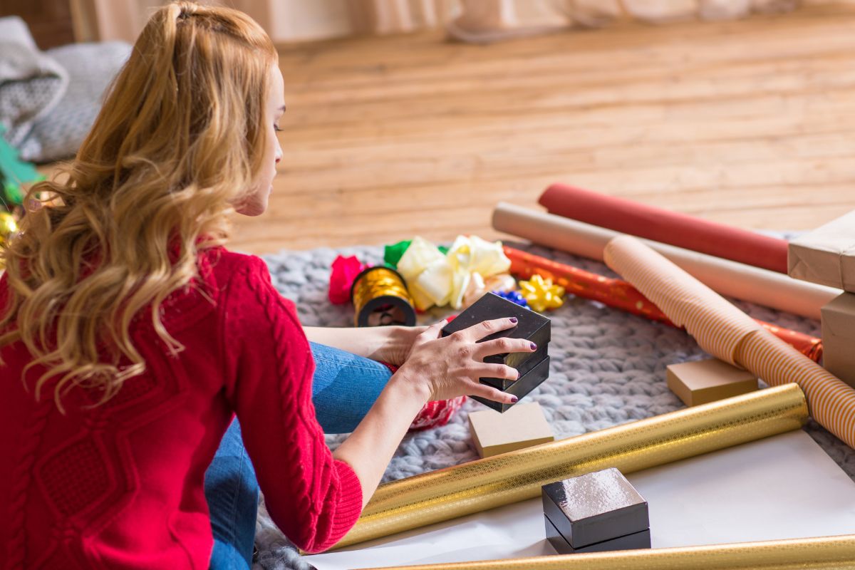 A picture of a lady wrapping a box.