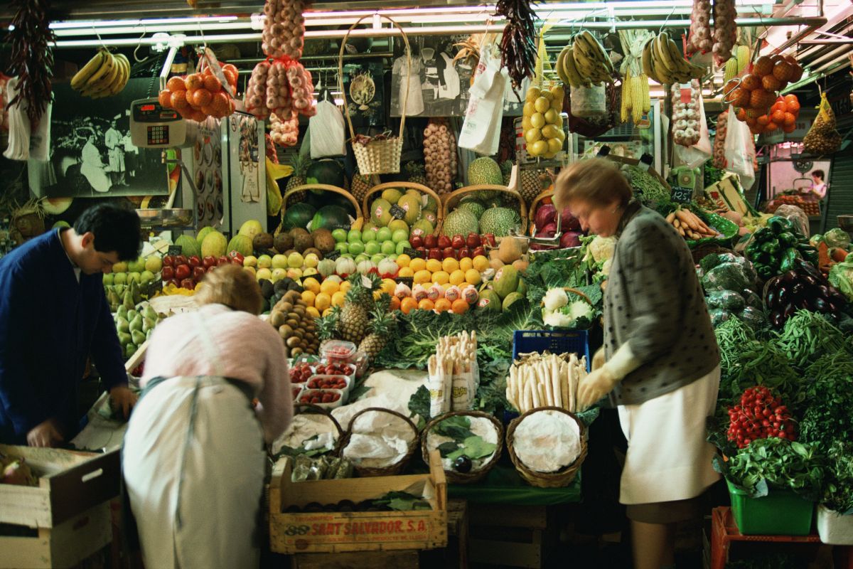 A picture of a lady at a farmer's market.