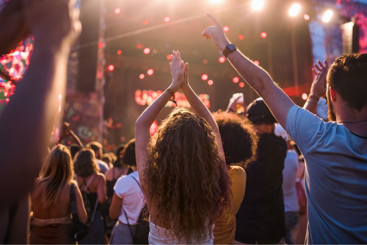 A picture of a concert in the park. 