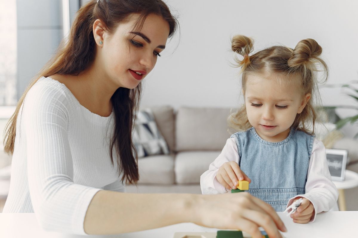 A picture of a lady babysitting.