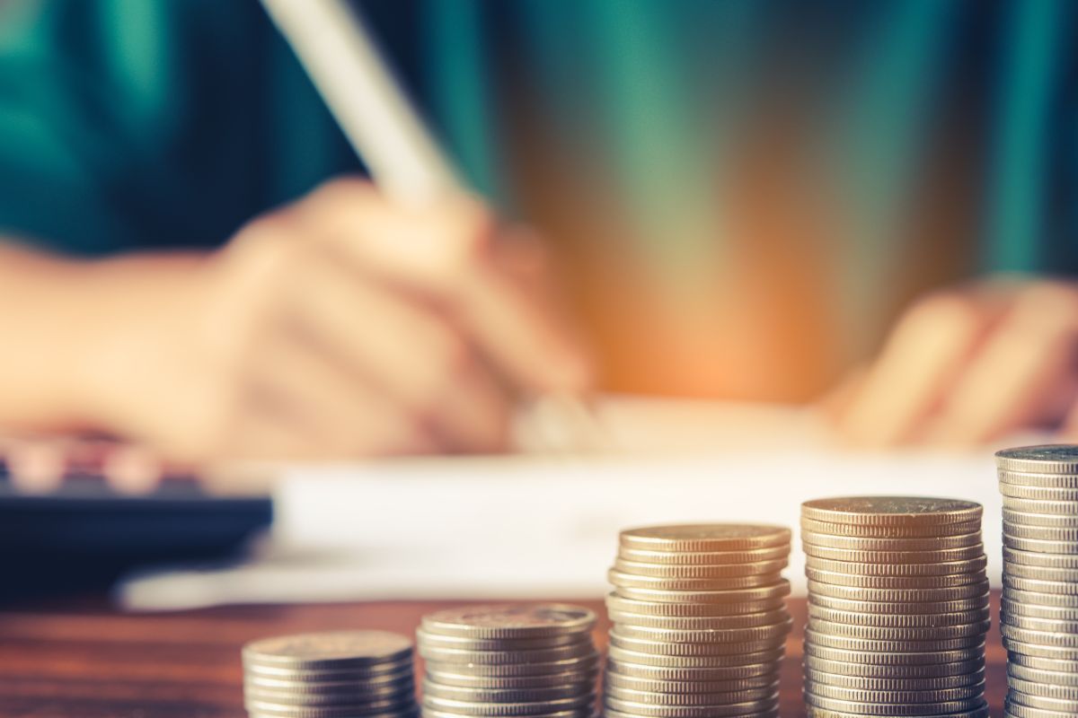 The photo is about a woman's hand budgeting with coins.