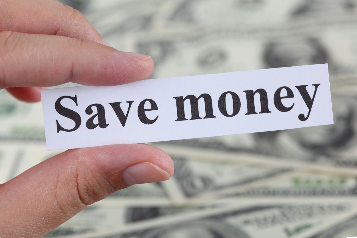The picture is about a woman's hand holding a paper with save money wording.