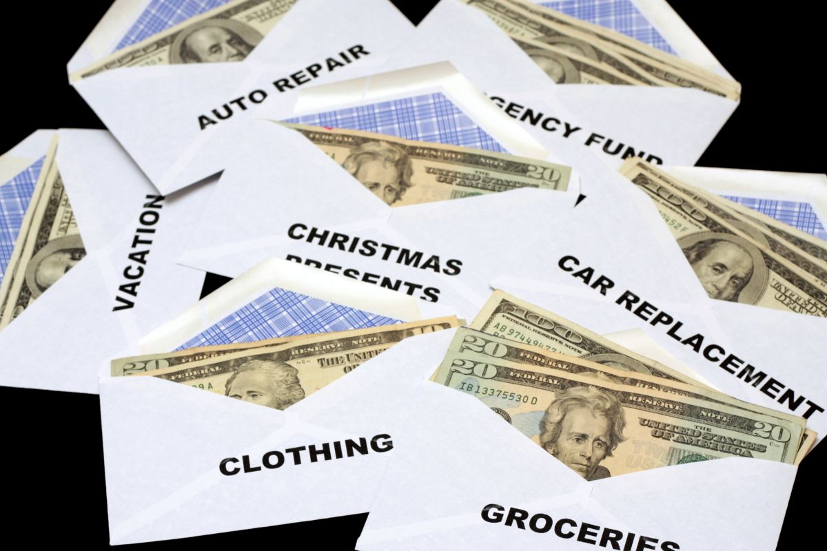 The photo shows envelopes with funding categories.