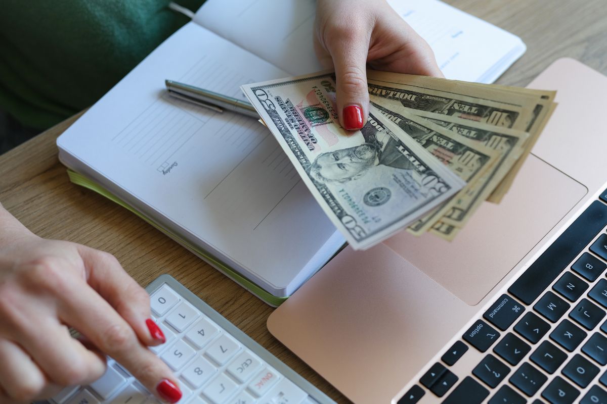 The photo is about a lady's hand doing a budgeting method.