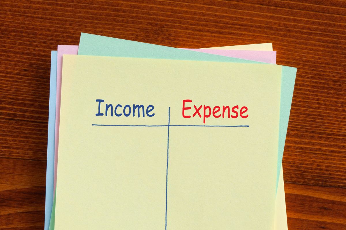 The picture of papers with income and expense wording.
