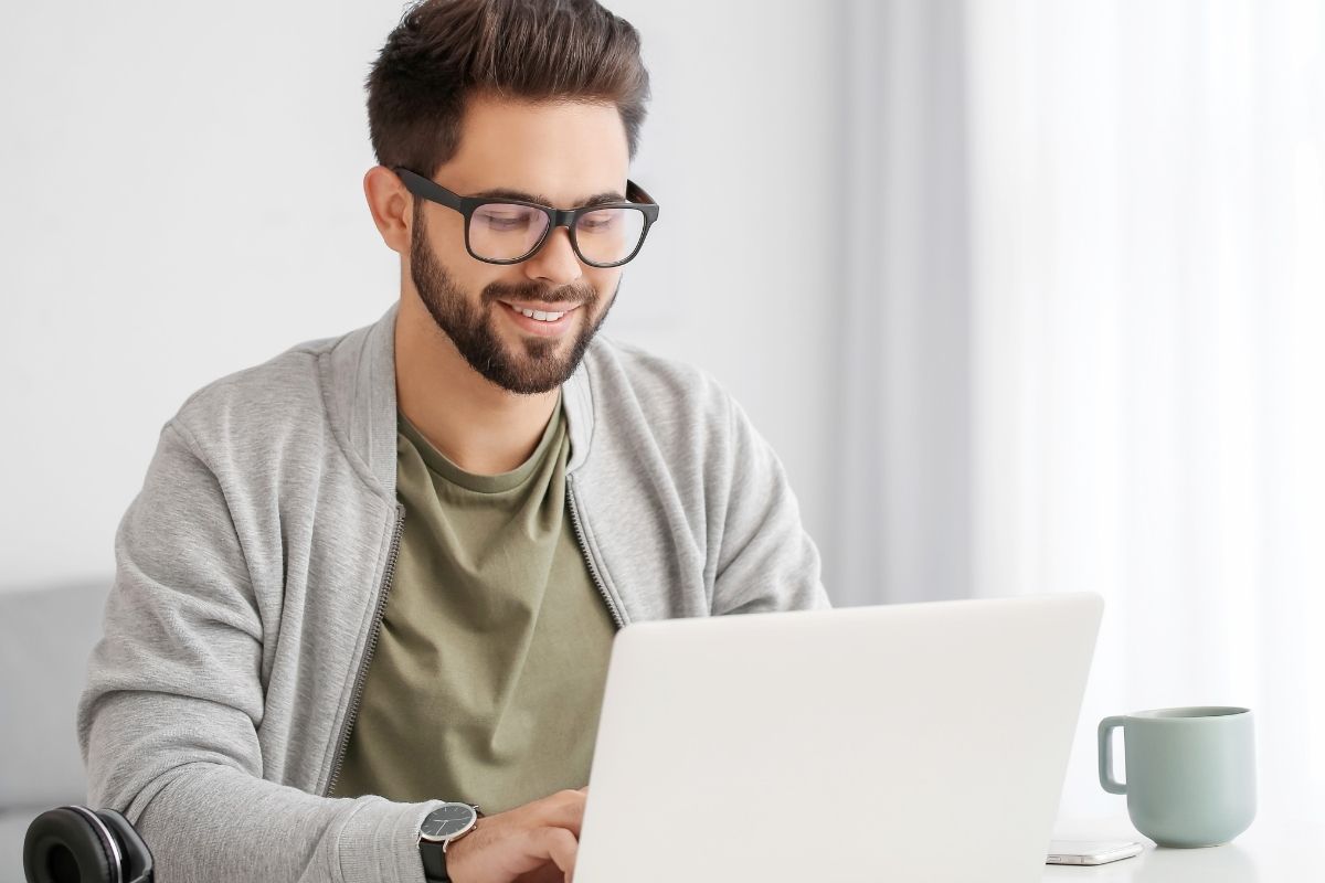 The image tells about a young man using a laptop to figure out the FI number.