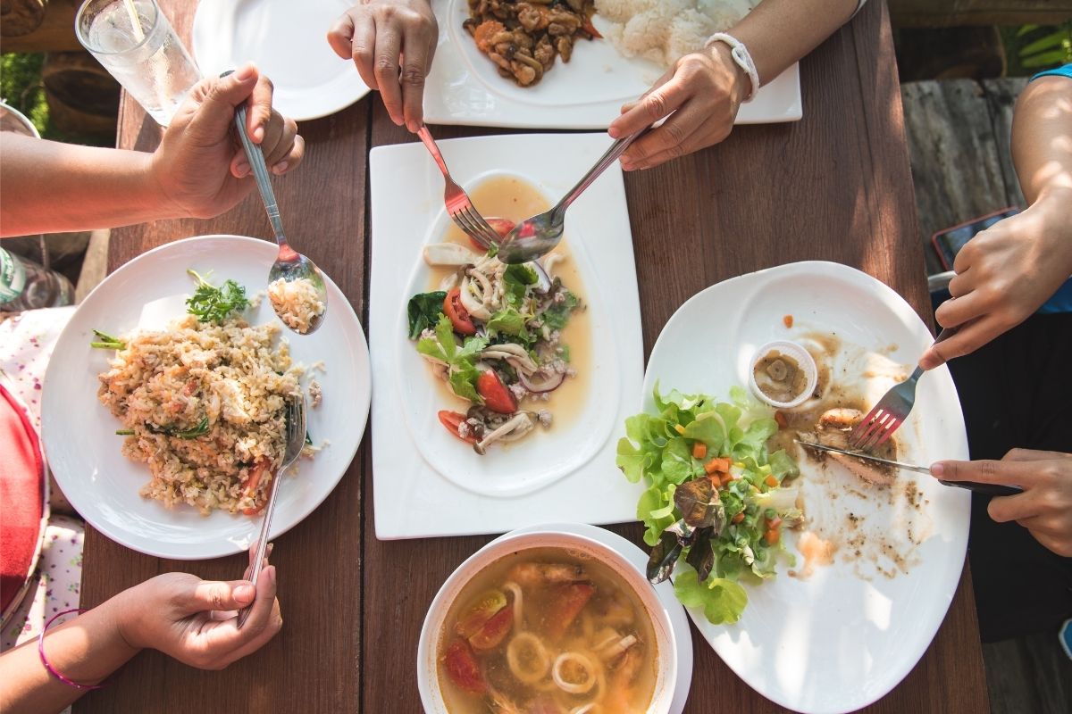The picture shows a group of people eating out at the restaurant.