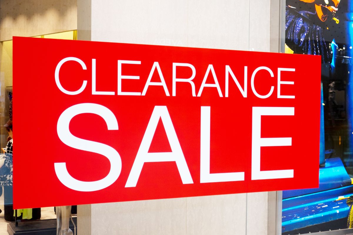 The photo is of a red sign for a clearance sale.