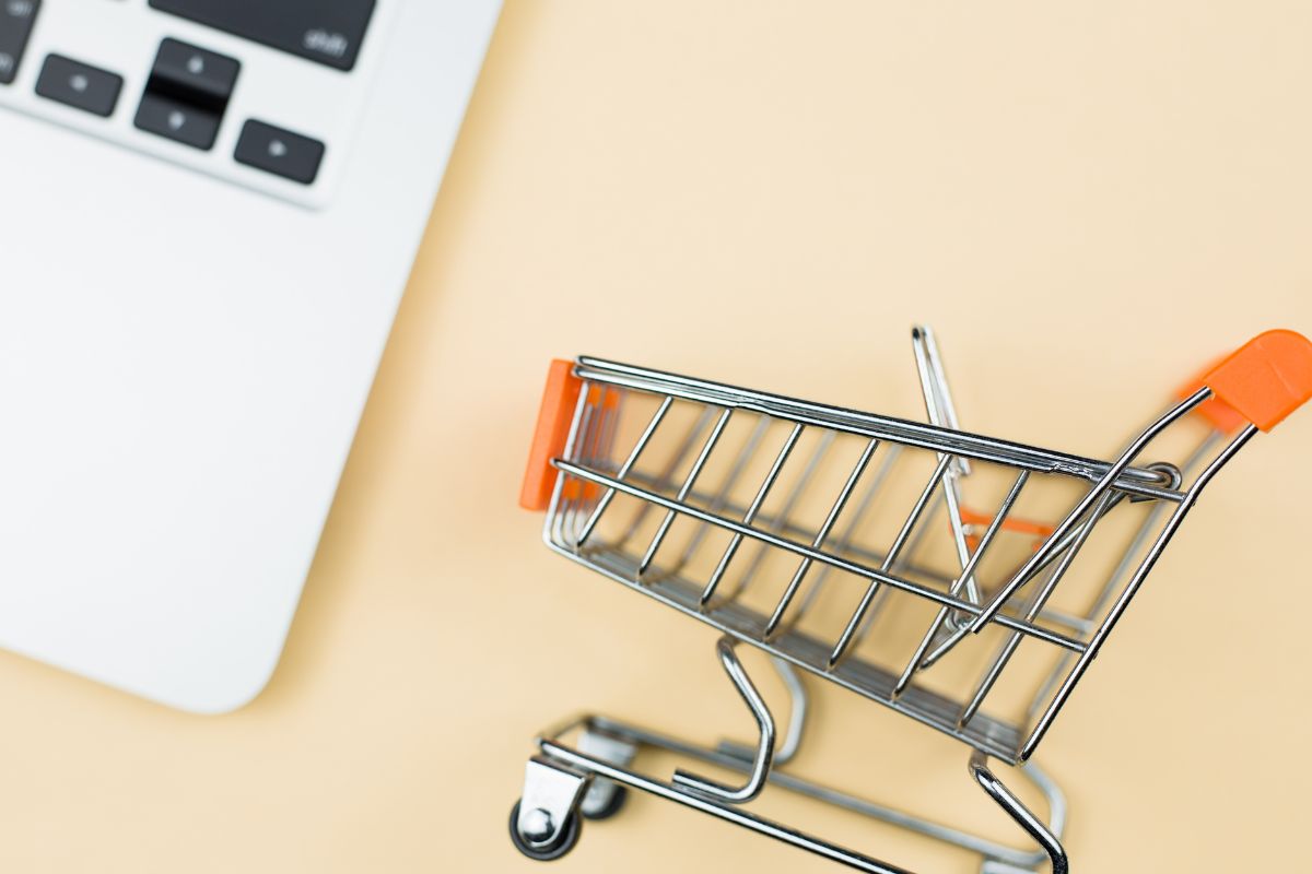 The photo is about a laptop and a cart for buy now, pay later plans.