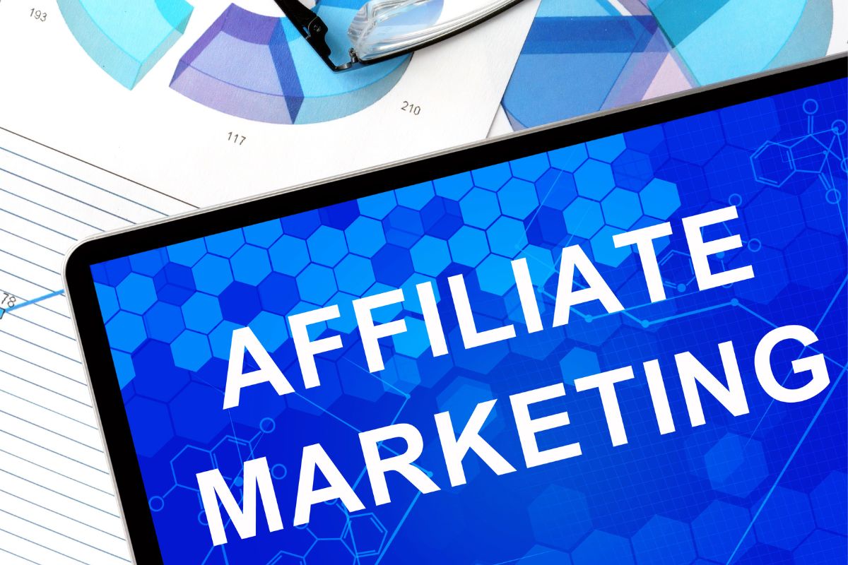 The photo shows a tablet device with an affiliate marketing screen display.
