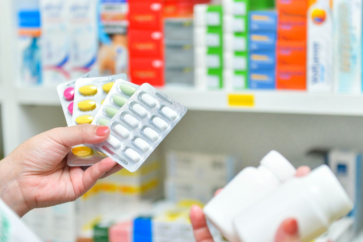 The image shows product displays and a girl's hand holding medicines referring to buying name brand vs generic.