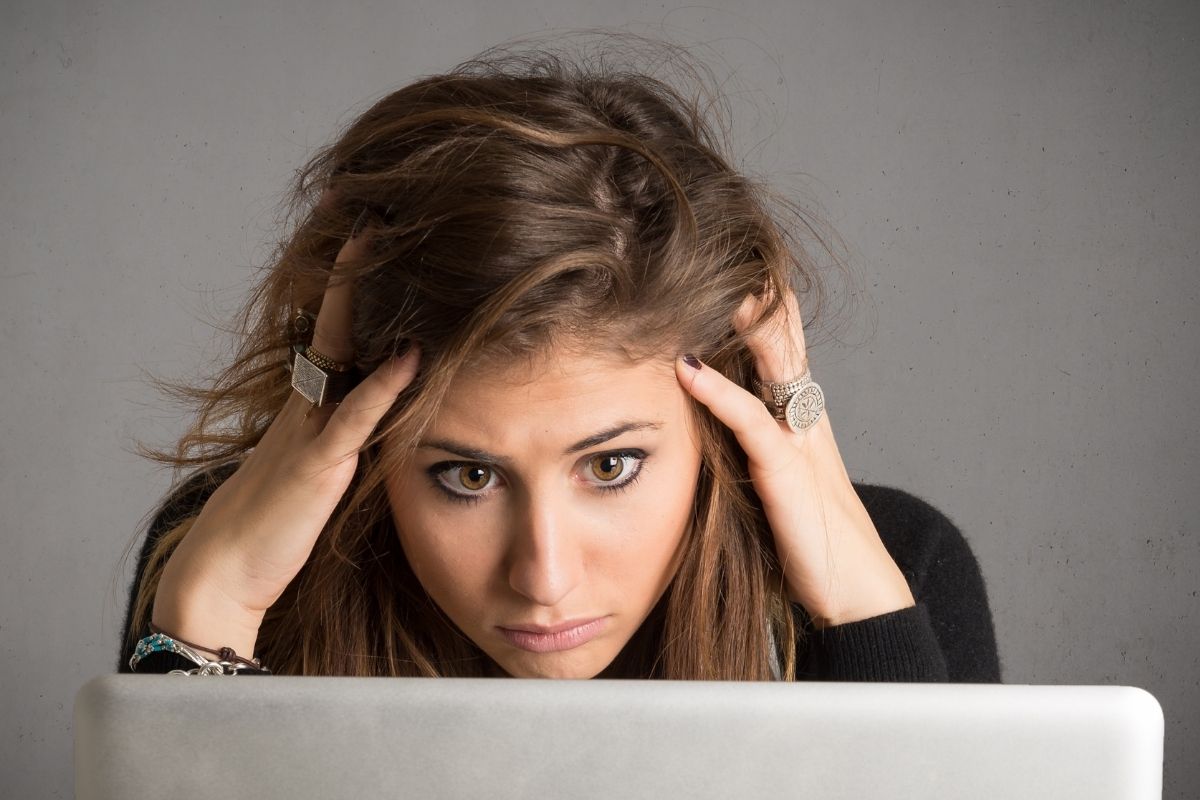 The picture tells about a girl looking at her laptop which refers to worries 