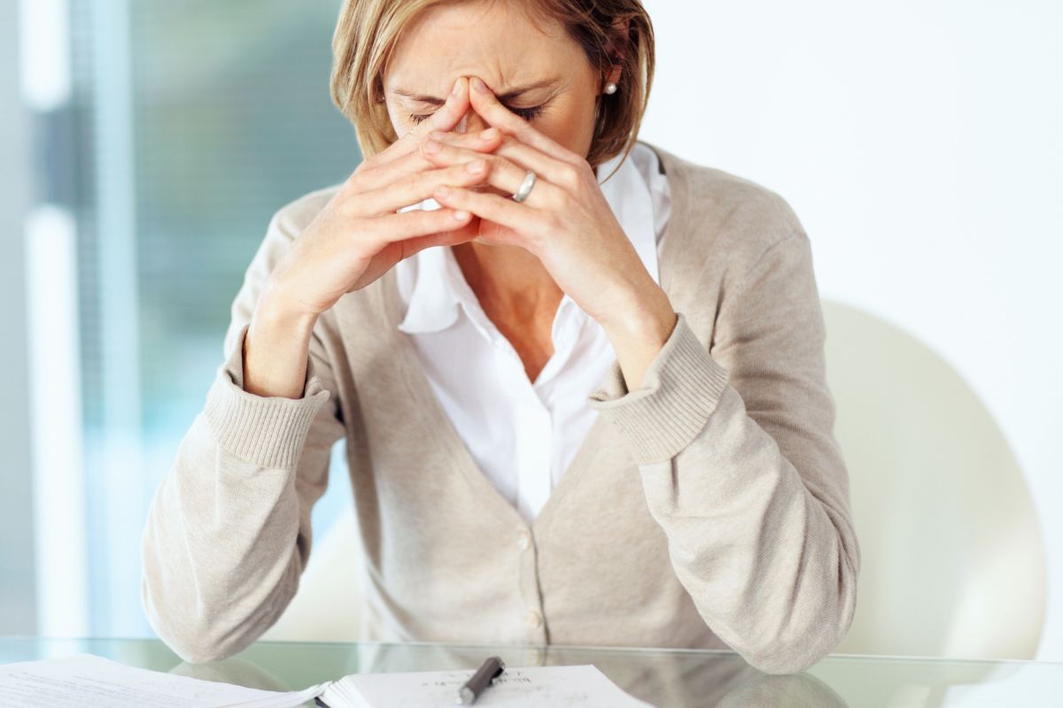 The image shows a frustrated women indicating that fear of failures