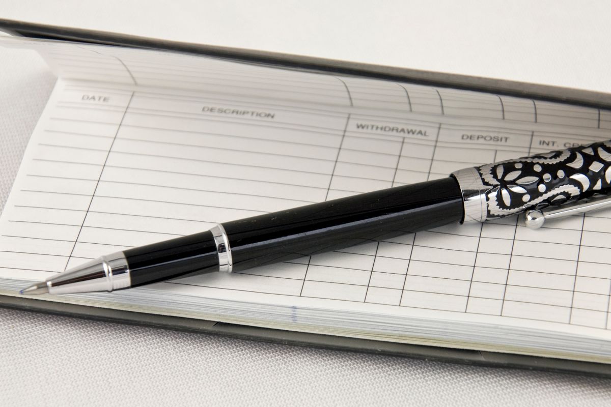Photo of a checkbook and pen.