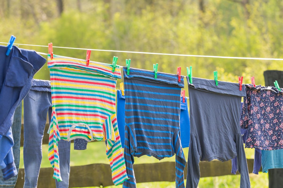 The image shows wet clothes hanging to dry.