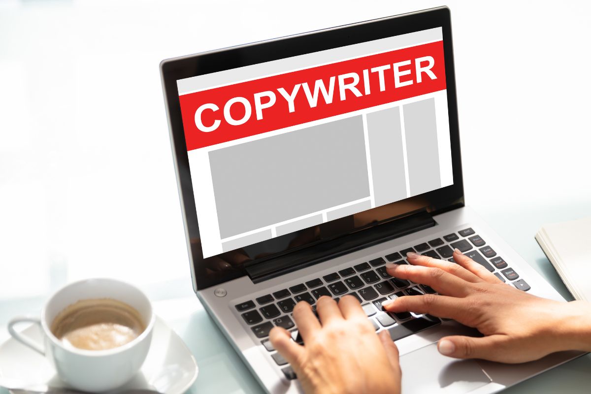The picture of a lady's hand copywriting on the laptop.