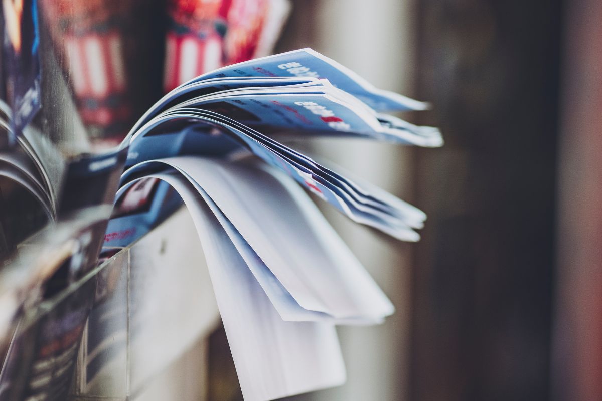 The photo tells about papers on the corner which refers to reading store flyers keeping food bills low and making every dollar count.