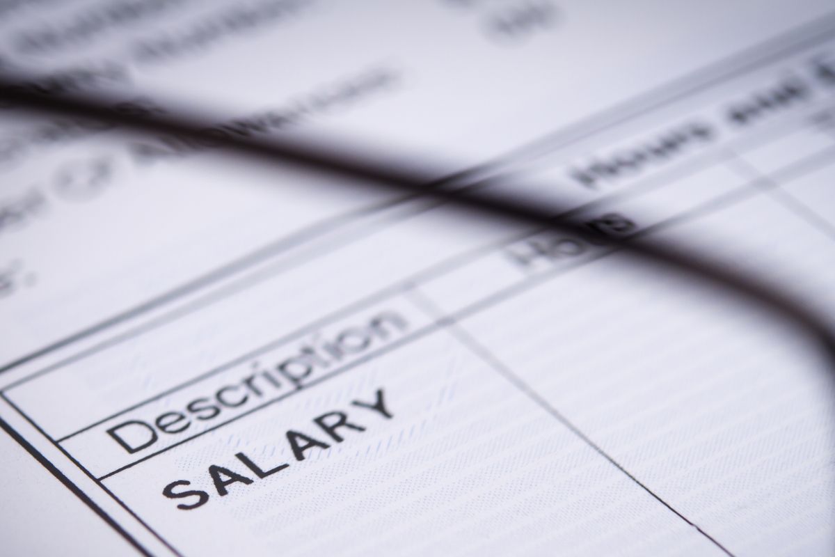 The picture tells about a paper with salary descriptions.