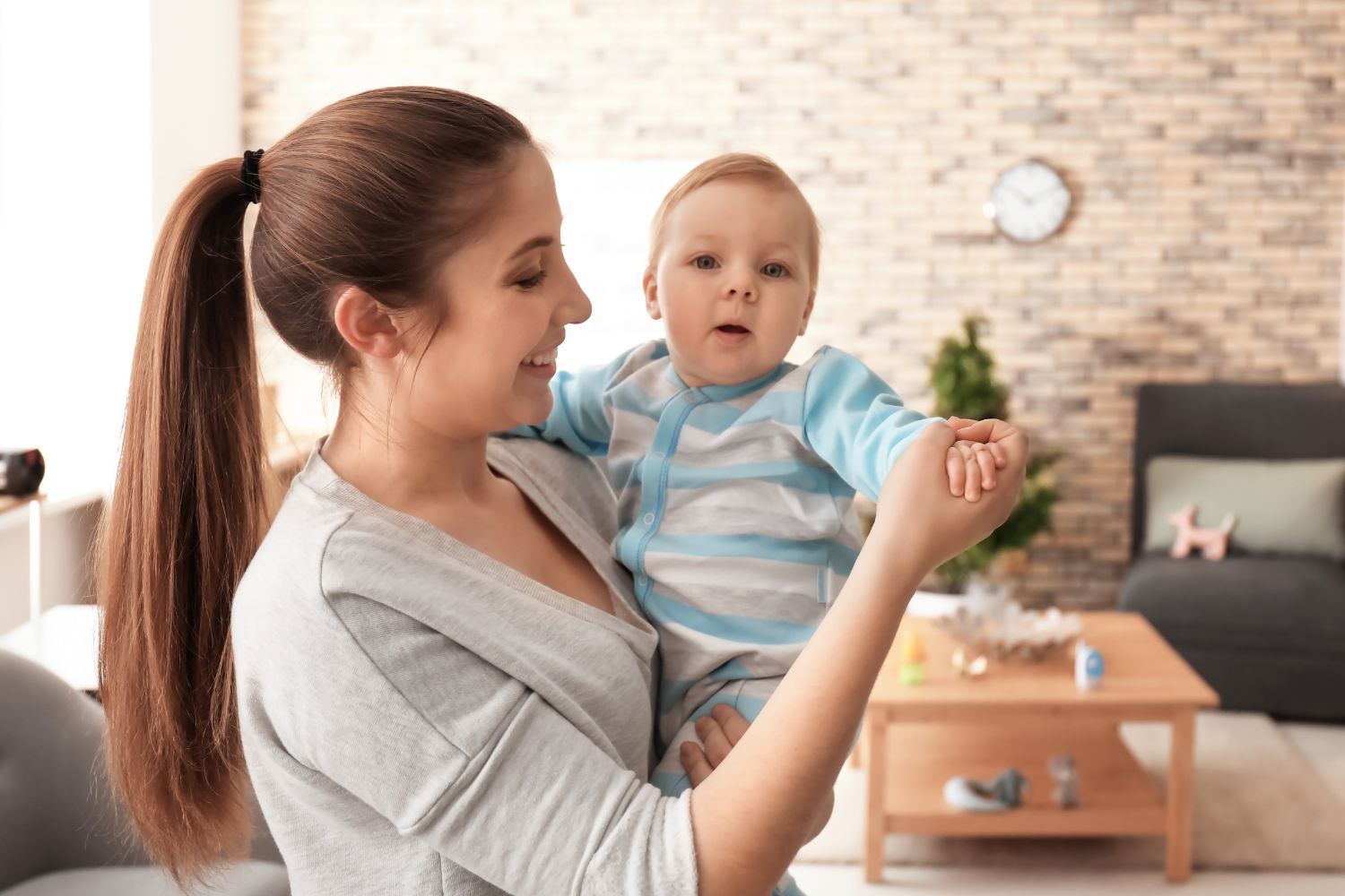 The picture shows a young lady carrying a baby.