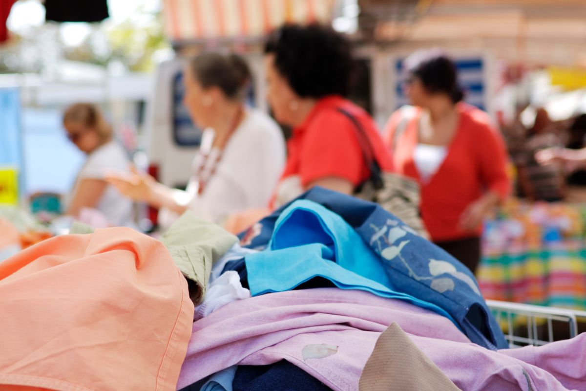 The image shows customers and clothes displayed at the store.